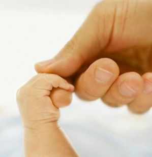 Infant Grabbing Man's Finger